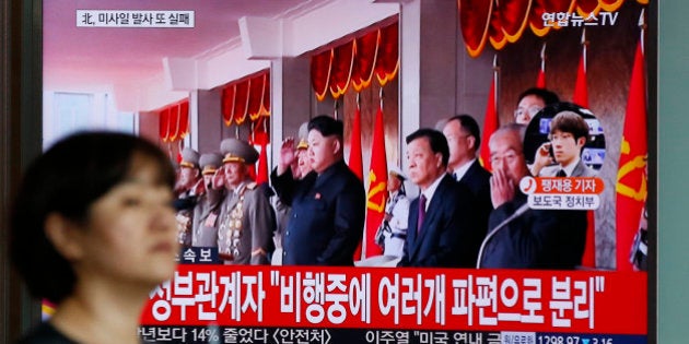 A woman walks by a public TV screen showing the North Korea's leader Kim Jong Un at the Seoul Train Station in Seoul, South Korea, Wednesday, June 22, 2016. In a remarkable show of persistence, North Korea on Wednesday fired two suspected powerful new Musudan midrange ballistic missiles, U.S. and South Korean military officials said, its fifth and sixth such attempts since April. The letters on top left,