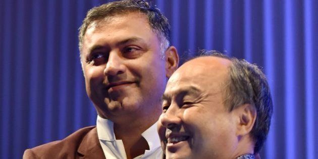 (FILES) This file picture taken on October 22, 2015 shows Masayoshi Son (R), SoftBank Chairman and CEO as he greets President Nikesh Arora at the SoftBank Academia Special Lecture in Tokyo.A former Google executive - seen as heir apparent to the founder of Japanese mobile communications giant SoftBank - has resigned from the company, it announced, June 21, 2016. SoftBank had just hours earlier cleared Nikesh Arora after an investor group accused him of misconduct and called for his ouster. / AFP / KAZUHIRO NOGI (Photo credit should read KAZUHIRO NOGI/AFP/Getty Images)
