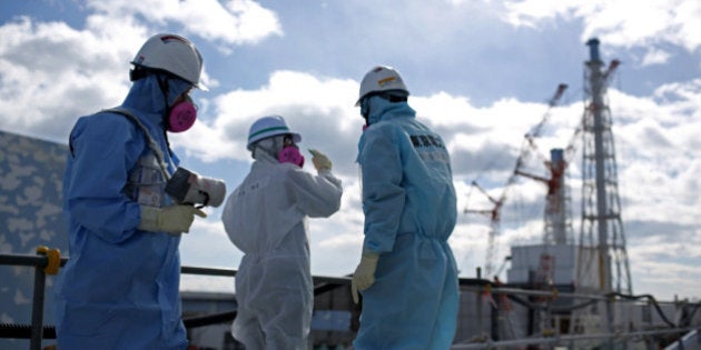 OKUMA, JAPAN - FEBRUARY 25: A TEPCO employee uses a radiation monitor as they show a member of the media a destroyed reactor at Fukushima Daiichi nuclear power plant on February 25, 2016 in Okuma, Japan. Five years on, the decontamination and decommissioning process at the Tokyo Electric Power Co.'s embattled Fukushima Daiichi nuclear power plant continues on February 25, 2016 in Okuma, Japan. March 11, 2016 marks the fifth anniversary of the magnitude 9.0 earthquake and tsunami which claimed the lives of 15,894, and the subsequent damage to the reactors at TEPCO's Fukushima Daiichi Nuclear Power Plant causing the nuclear disaster which still forces 99,750 people to live as evacuees away from contaminated areas. (Photo by Christopher Furlong/Getty Images)