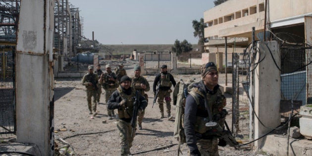 MOSUL, IRAQ - FEBRUARY 23: Iraqi Emergency Response Division (ERD) soldiers advance on the Islamic State occupied Mosul Airport in west Mosul, part of the offensive to retake the city some two years after it fell to the hardline jihadist group, February 23, 2017. Iraqi forces encountered stiff resistance with improvised explosives, heavy mortar fire and snipers hampering their advance before they successfully took the airport. (Photo by Martyn Aim/Getty Images)