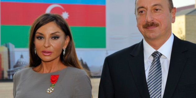 Azerbaijan's President Ilham Aliev (R) and first lady Mehriban Aliyeva pose after she was awarded with the Legion d'Honneur medal in Baku, October 7, 2011. REUTERS/Philippe Wojazer (AZERBAIJAN - Tags: POLITICS)