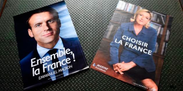 Electoral posters of French presidential election candidate for the En Marche ! movement Emmanuel Macron (L) and French presidential election candidate for the far-right Front National (FN) party Marine Le Pen (R) are displayed in a warehouse in Gonesse, north of Paris on April 26, 2017, ahead of the second round of the presidential election. / AFP PHOTO / Lionel BONAVENTURE (Photo credit should read LIONEL BONAVENTURE/AFP/Getty Images)