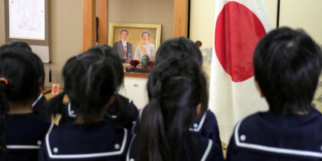 Students recite the Imperial Rescript on Education and Confucian Analects in front of JapanÃs national flag, a picture of Japanese Emperor Akihito and Empress Michiko, and a hanging scroll of Confucius at Tsukamoto kindergarten in Osaka, Japan, November 30, 2016. Picture taken on November 30, 2016. REUTERS/Ha Kwiyeon