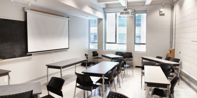 A modern university lecture hall and classroom space set up with movable tables for running a 'seminar' type class.