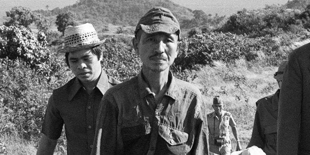 This picture taken on March 11, 1974 shows former Japanese imperial army soldier Hiroo Onoda (2nd L) walking from the jungle where he had hidden since World War II, on Lubang island in the Philippines. Onoda, who hid in the Philippine jungle for three decades because he did not believe World War II was over, has died in Tokyo on January 17, 2014, at the age of 91. The former soldier waged a guerilla campaign in Lubang Island near Luzon until he was finally persuaded in 1974 that peace had broken out. JAPAN OUT AFP PHOTO / JIJI PRESS (Photo credit should read JIJI PRESS/AFP/Getty Images)