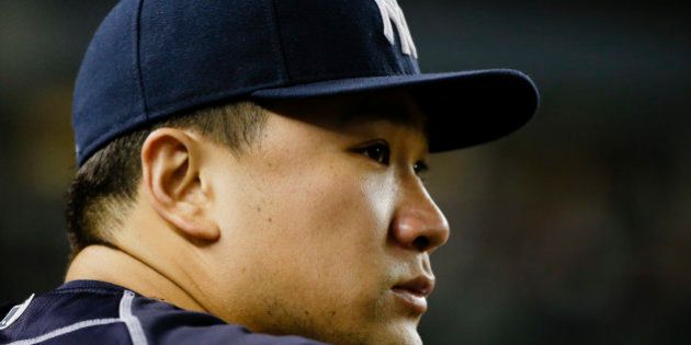 New York Yankees starting pitcher Masahiro Tanaka, of Japan, watches his team play during the ninth inning of a baseball game against the Cleveland Indians Thursday, Aug. 20, 2015, in New York. The Indians won 3-2. (AP Photo/Frank Franklin II)