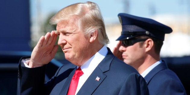 U.S. President Donald Trump returns a salute as he steps from Air Force One to tour the Boeing South Carolina facility in North Charleston, South Carolina, U.S., February 17, 2017. REUTERS/Kevin Lamarque