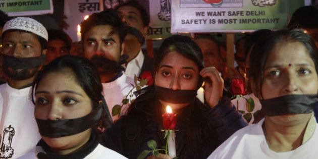 NEW DELHI, INDIA - DECEMBER 16: People lit candles and held solidarity marches in remembrance of the horrific December 16 Delhi gang-rape that shook the nation at the munirka bus stand where she boarded that bus on the second anniversary on December 16, 2014 in New Delhi, India. On December 16, 2012, a 23-year-old physiotherapy student was brutally gang raped and by six men, including a juvenile, in a bus. (Photo by Sanjeev Verma/Hindustan Times via Getty Images)