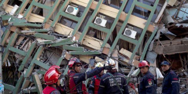 Rescue workers from Venezuela organize themselves before they search for earthquake survivors in Portoviejo, Ecuador, Monday, April 18, 2016. The strongest earthquake to hit Ecuador in decades flattened buildings and buckled highways along its Pacific coast, sending the Andean nation into a state of emergency. (AP Photo/Rodrigo Abd)