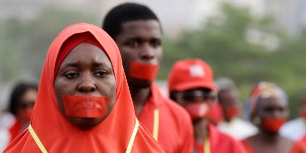 People march during a silent protest calling on the government to rescue the kidnapped girls of the government secondary school in Chibok, who were abducted a year ago, in Abuja, Nigeria, Monday, April 13, 2015. Nearly 300 schoolgirls from Chibok were abducted in a mass kidnapping on the night of April 14-15. Dozens escaped on their own but 219 remain missing. (AP Photo/Sunday Alamba)