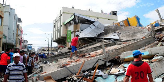 Local residents and rescue workers in the city of Manta in Manabi province search on April 17, 2016 through the rubble for survivors of the 7.8-magnitude quake that hit Ecuador on Saturday. At least 235 people were killed by the powerful earthquake that destroyed buildings and a bridge and sent terrified residents scrambling from their homes, authorities said Sunday. / AFP / ARIEL OCHOA (Photo credit should read ARIEL OCHOA/AFP/Getty Images)