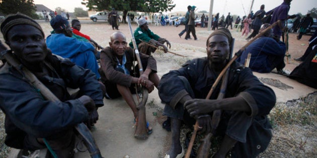 Vigilantes and local hunters armed with locally made guns gathered before they go on patrol in Yola, Nigeria, Wednesday, Nov. 25, 2014. Suspected Boko Haram gunmen killed at least 20 people in an attack Monday on two villages on the outskirts of Chibok, the town where more than 200 schoolgirls were abducted in April, said a Nigerian civilian defense officer. (AP Photo/Sunday Alamba)