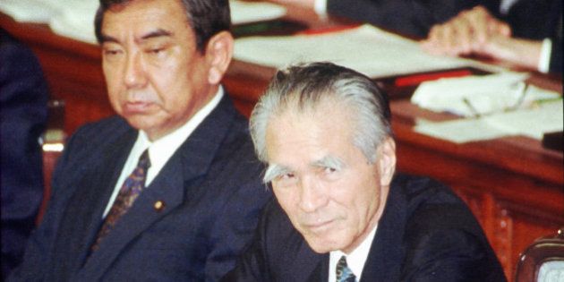 Japanese Prime Minister Tomiichi Murayama jots down notes as he awaits the result of no-confidance vote at the Lower House plenary session in Tokyo Tuesday, June 13 1995. Murayama received the embarrassment by the opposition's non-confidence motion on the ave of his departure for the G7 summit but the motion was rejected. At left is Foraign Minister Yohei Kono. (AP Photo)