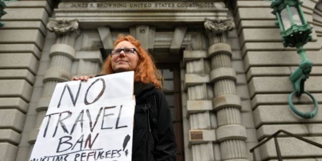 Beth Kohn holds up a sign in front of the United States Court of Appeals for the Ninth Circuit in San Francisco, California on February 07, 2017. A federal appeals court heard arguments on Tuesday on whether to lift a nationwide suspension of President Donald Trump's travel ban targeting citizens of seven Muslim-majority countries. / AFP / Josh Edelson (Photo credit should read JOSH EDELSON/AFP/Getty Images)