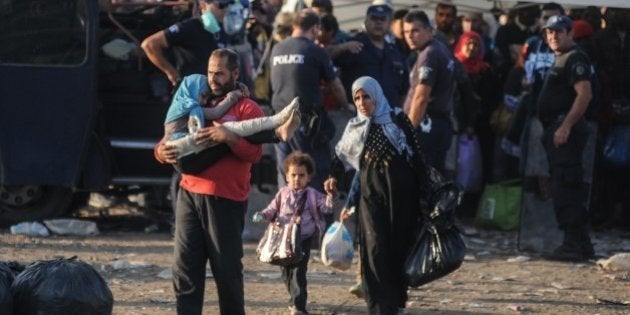 GEVGELIJA, MACEDONIA - SEPTEMBER 5: Refugees cross the border between Macedonia and Greece, near the town of Gevgelija, Macedonia on September 5, 2015. The Gevgelija-Presevo journey is just a part of the journey that the refugees are forced to make which takes them from Turkey, across Greece, Macedonia and Serbia to Hungary. (Photo by Thomas Campean /Anadolu Agency/Getty Images)