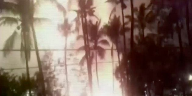 In this image made from video, a flash from an explosion is seen from the ground during a fireworks show at a temple in Kollam, in the southern Indian state of Kerala, early Sunday, April 10, 2016. A number of people were killed and many more injured in a massive fire that broke out in a temple caused by fireworks that had been stored in the temple in preparation for the Hindu new year festival, according to an official. (KK Productions via AP Video) INDIA OUT