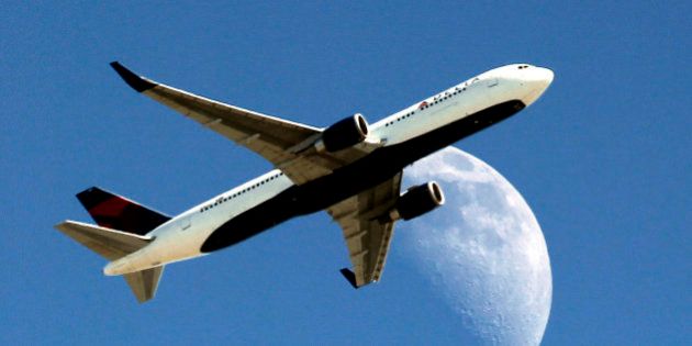 Delta Airlines flight DL370 from Managua Nicaragua crosses over a waxing crescent moon as it passes over Whittier, Calif. on approach to the Los Angeles Airport (LAX) on Labor Day, Monday, Sept. 1, 2014. (AP Photo/ Nick Ut )