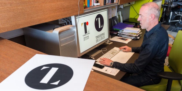 Belgian designer Olivier Debie shows the official emblem for the 2020 Tokyo Olympics and his logo for the Theatre de Liege on a screen in his office in Liege, Belgium, on Friday July 31, 2015. The designer of the emblem for the Tokyo 2020 Olympics says he did not copy a Belgian theater logo that looks similar. Kenjiro Sano's emblem for the Tokyo games bears a striking resemblance to the logo for Belgium's Theatre de Liege, created by designer Debie. (AP Photo/Geert Vanden Wijngaert)