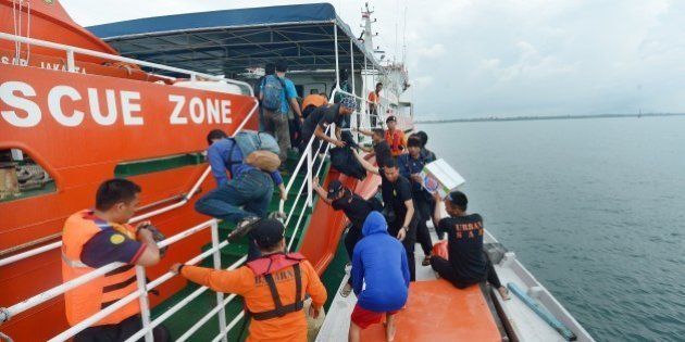 Members of an Indonesian search and rescue team prepare to set off to search at sea for missing AirAsia flight QZ8501 from Manggar in East Belitung on December 30, 2014. Dozens of planes and ships searching Indonesian waters for the missing AirAsia Airbus plane focused on a patch of oil for possible clues, as a senior official warned on December 29 the aircraft was likely at the bottom of the sea. AFP PHOTO / ADEK BERRY (Photo credit should read ADEK BERRY/AFP/Getty Images)