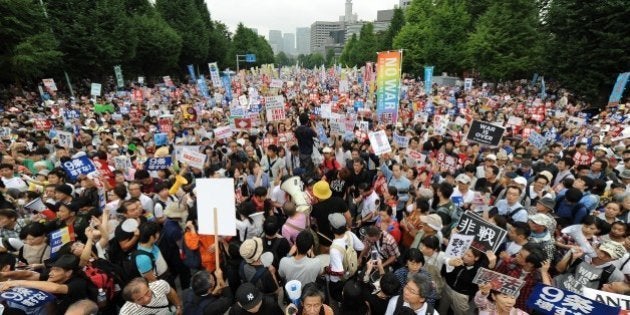 TOKYO, JAPAN - AUGUST 30 : People take part a major protest labeled as a nationwide movement for 1 million people organized near the National Diet Building on August 30, 2015, in Tokyo, Japan to voice opposition to security-related bills and Japan Prime Minister Shinzo abe's administration security policy. (Photo by David MAREUIL/Anadolu Agency/Getty Images)