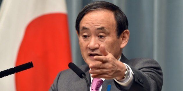 Japan's Chief Cabinet Secretary Yoshihide Suga points to a journalist at a press conference at the prime minister's official residence in Tokyo on March 19, 2015. Japan said at least three nationals were killed when gunmen stormed Tunisia's national museum, in what his government condemned as a 'despicable act of terrorism'. AFP PHOTO / Yoshikazu TSUNO (Photo credit should read YOSHIKAZU TSUNO/AFP/Getty Images)