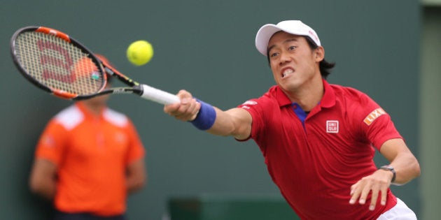 Japan's Kei Nishikori returns a shot against Serbia's Novak Djokovic in the finals of the Miami Open on Sunday, April 3, 2016, at Cradon Park Tennis Center in Key Biscayne, Fla. Djokovic won, 6-3, 6-3. (Carl Juste/Miami Herald/TNS via Getty Images)