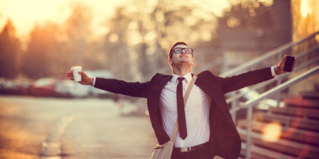 Businessman smiling with arms outstretched