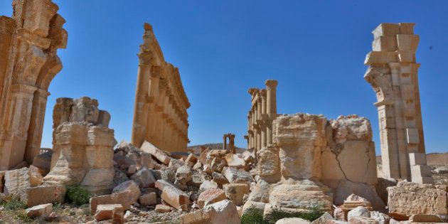 In this picture taken Friday, April 1, 2016, damage is seen in the ancient city of Palmyra in the central city of Homs, Syria. Explosions rocked the ancient town of Palmyra on Friday and on the horizon, black smoke wafted behind its majestic Roman ruins, as Syrian army experts carefully detonated hundreds of mines they say were planted by Islamic State militants before they fled the town. (AP Photo)