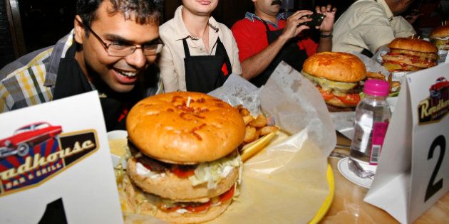 NEW DELHI, INDIA - JULY 04: Burger Demolition competition at Roadhouse Bar and Grill at Doubletree by Hilton Hotel in Mayuir Vihar, New Delhi. (Photo by K Asif/India Today Group/Getty Images)