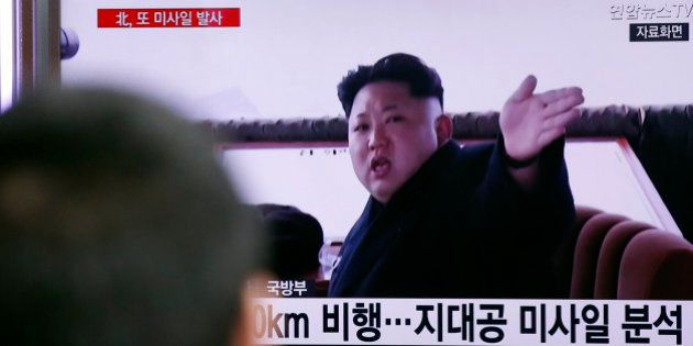 A man watches a TV news program showing a file footage of North Korean leader Kim Jong Un at Seoul Railway Station in Seoul, South Korea, Friday, April 1, 2016. North Korea fired a short-range missile into the sea on Friday, Seoul officials said, hours after the U.S., South Korean and Japanese leaders warned the North it will face tougher sanctions if it continues with provocations. The Korean letters at bottom read: