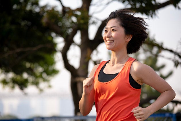 Woman running at sunset beach