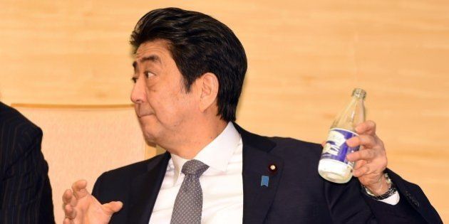 Japan's Prime Minister Shinzo Abe pours water into a glass while looking at visiting South African Deputy President Cyril Ramaphosa (not pictured) during their meeting at Abe's official residence in Tokyo on August 24, 2015. Ramaphosa arrived here on August 22 for a four-day working visit. AFP PHOTO / POOL / TOSHIFUMI KITAMURA (Photo credit should read TOSHIFUMI KITAMURA/AFP/Getty Images)