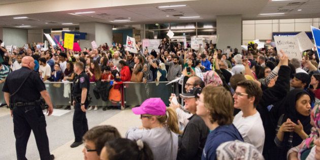 People gather to protest against the travel ban imposed by U.S. President Donald Trump's executive order, at Dallas/Fort Worth International Airport in Dallas, Texas, U.S. January 28, 2017. REUTERS/Laura Buckman