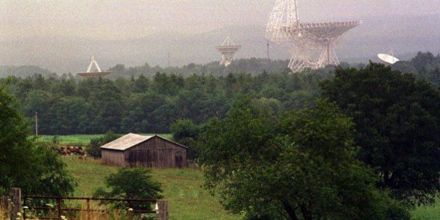 TO GO WITH STORY TITLED RADIO TELESCOPE--The Robert C. Byrd Telescope and its smaller companions at the rural National Radio Astronomy Observatory at Green Bank, W.Va., loom above the trees July 27, 2001. The Byrd telescope and its companions collect radio waves and use them to study galaxies, pulsars, planets, asteroids and forming stars. (AP Photo/Chris Dorst)
