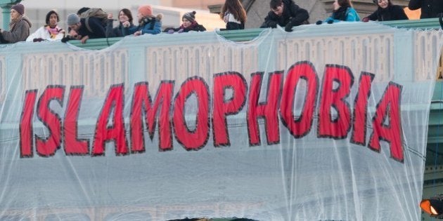 LONDON, UNITED KINGDOM - JANUARY 20: Anti Donald Trump demonstrators drop a banner, reading 'Unite Against Islamophobia' over Southwark Bridge in London, England, U.K on January 20, 2017. The protest was ahead of the inauguration ceremony of Donald Trump, the 45th President of the United States. (Photo by Ray Tang/Anadolu Agency/Getty Images)