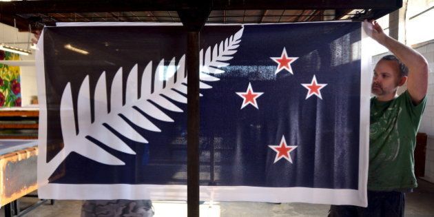 Factory workers Garth Price (R) and Andrew Smith (L) hang new designs of the national flag of New Zealand at a factory in Auckland, New Zealand, November 24, 2015. New Zealanders could be a step closer to getting a new flag after the first phase of a two-part referendum wrapped up on Friday but many people are not in the mood for change. The current flag features Britain's Union Jack in the corner and four red stars in a Southern Cross formation, indicating New Zealand's location in the South Pacific. Prime Minister John Key announced a referendum this year to settle the question and called for designs. More than 10,000 entries, including flags bearing the native kiwi bird and sheep, were whittled down to a short-list of five and the vote on Friday is aimed at settling on the favourite. Picture taken November 24, 2015. REUTERS/Rafael Ben-Ari EDITORIAL USE ONLY. NO RESALES. NO ARCHIVE
