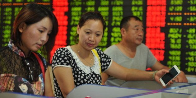 FUYANG, CHINA - JULY 28: (CHINA OUT) Investors observe electric screen at a stock exchange hall on July 28, 2015 in Fuyang, China. Chinese shares dropped on Tuesday, with The benchmark Shanghai Composite Index lost 62.56 points, or 1.68 percent, to close at 3,663 points. The Shenzhen Component Index shed 176.27 points, or 1.41 percent, to 12,316.78 points. (Photo by ChinaFotoPress/ChinaFotoPress via Getty Images)