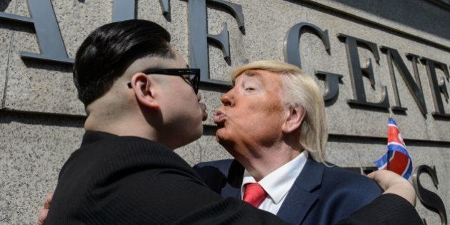North Korean leader Kim Jong-un, impersonated by Hong Kong actor Howard (L), and US President Donald Trump, impersonated by US actor Dennis, pose outside the US consulate in Hong Kong on January 25, 2017.US President Donald Trump and North Korean leader Kim Jong-un might never be best buddies, but convincing impersonators are giving Hong Kongers a glimpse of what their improbable friendship might look like. Describing themselves as political satirists, the pair hugged and pretended to kiss as they posed for photos outside the US consulate on January 25. / AFP / Anthony WALLACE (Photo credit should read ANTHONY WALLACE/AFP/Getty Images)