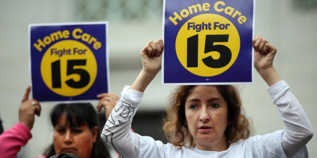 LOS ANGELES, CA JUNE 03, 2015 -- Ingrid Alarcon, right, joins supporters on the steps of Los Angeles City Hall June 3, 2015 before the City Council voted on an ordinance that would raise the minimum wage in Los Angeles to $15 per hour by 2020. The City Council gave its tentative support to the measure last month, and the panel is now voting on the language of the law. Under the proposed ordinance, the city minimum wage would increase to $10.50 per hour in July 2016 for businesses with 26 or more employees, with a one-year delay for smaller businesses. By 2016, the state minimum wage will have risen to $10 per hour. (Al Seib / Los Angeles Times via Getty Images)