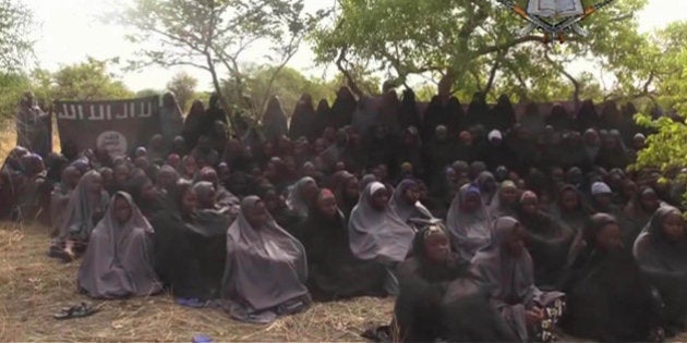 FILE - This Monday May 12, 2014 file image taken from video by Nigeria's Boko Haram terrorist network, shows the alleged missing girls abducted from the northeastern town of Chibok. Islamic extremists killed 35 people and kidnapped at least 185, fleeing residents said Thursday of an attack near the town where nearly 300 schoolgirls were taken hostage in April. Teenager Aji Ibrahim said he was lucky to escape into the bushes.