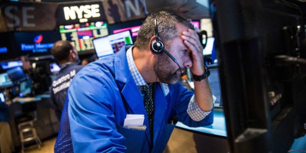 NEW YORK, NY - AUGUST 20: A trader works on the floor of the New York Stock Exchange during the afternoon of August 20, 2015 in New York City. The Dow Jones continued its plunge south, losing over 350 points today. (Photo by Andrew Burton/Getty Images)