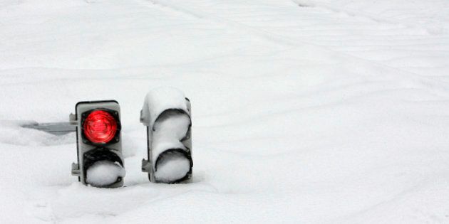 Railway traffic lights are covered in snow in Puente de los Fierros, in the northern Spanish region of Asturias, January 25, 2007. REUTERS/Eloy Alonso (SPAIN)