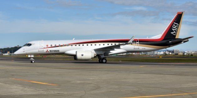 Japan's first domestically produced passenger jet, the Mitsubishi Regional Jet (MRJ), arrives at Nagoya airport in Aichi prefecture on November 11, 2015, following its maiden test flight. Japan's first domestic passenger jet successfully took off on its maiden test flight November 11, culminating a decade of development for a programme aimed at competing with Brazilian and Canadian rivals in the global market for smaller aircraft. AFP PHOTO / KAZUHIRO NOGI (Photo credit should read KAZUHIRO NOGI/AFP/Getty Images)