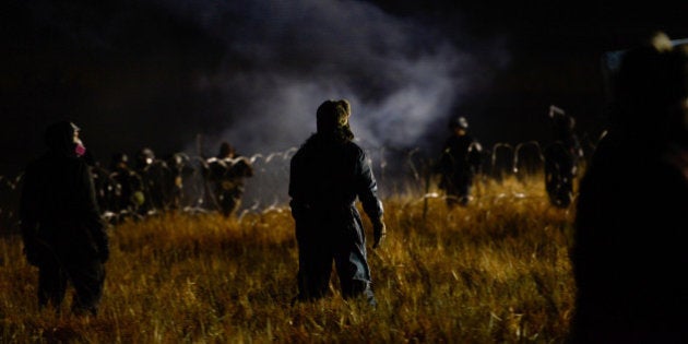 Protesters stand off with police during a protest against plans to pass the Dakota Access pipeline near the Standing Rock Indian Reservation, near Cannon Ball, North Dakota, U.S. November 20, 2016. REUTERS/Stephanie Keith