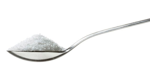 'sugar/salt on teaspoon, sideview isolated on white'
