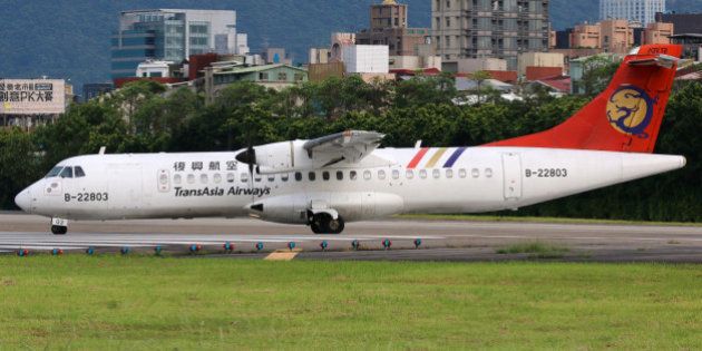 Taipei, Taiwan - May 18, 2014: A TransAsia Airways ATR 72-500 with the registration B-22803 taxis at Taipei Songshan Airport (TSA) in Taiwan. TransAsia Airways is a private airline from Taiwan.