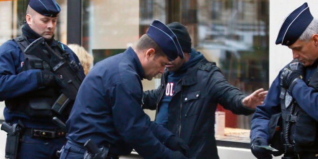 A troublemaker is arrested by French Police officers in front of the Bataclan concert hall in Paris, France, Sunday, Nov. 13, 2016 after a ceremony held for the victims of last year's Paris attacks which targeted the Bataclan concert hall as well as a series of bars and killed 130 people. (AP Photo/Francois Mori)