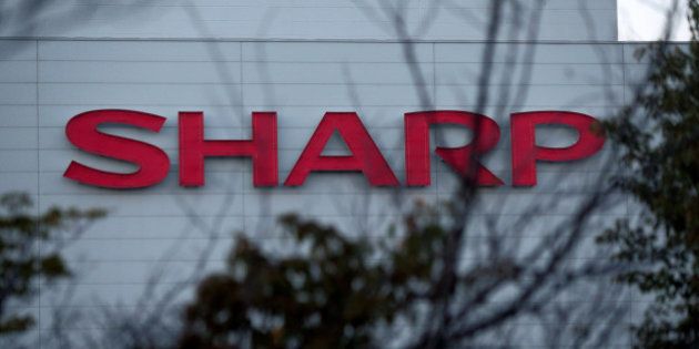 The Sharp Corp. logo is displayed at the company's Kameyama plant in Kameyama City, Mie Prefecture, Japan, on Wednesday, Oct. 3, 2012. Last month, Sharp said it had pledged the Kameyama plant as collateral along with most of its properties, including the company headquarters in Osaka, in return for 360 billion yen ($4.6 billion) in loans to stay afloat. Photographer: Yuzuru Yoshikawa/Bloomberg via Getty Images