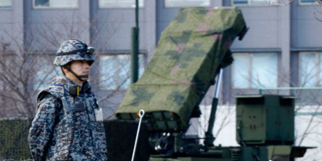 A Japan Self-Defense Force member stands by a PAC-3 Patriot missile unit deployed for North Korea's rocket launch at the Defense Ministry in Tokyo, Sunday, Jan. 31, 2016. Japan's Defense Ministry installed missile interceptors at their headquarters in central Tokyo on Friday amid signs that North Korea may be preparing to launch a rocket or missile. (AP Photo/Shizuo Kambayashi)