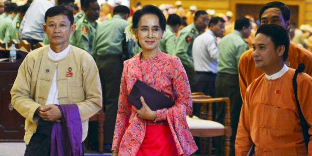 Myanmar opposition leader Aung San Suu Kyi, center, walks along with other lawmakers of her National League for Democracy party as they leave after a regular session of the lower house of parliament Monday, Feb 1, 2016 in Naypyitaw, Myanmar. Myanmar's parliament, dominated by Suu Kyi's party, on Monday began a new and historic session that will install the country's first democratically elected government in more than 50 years. (AP Photo/Aung Shine Oo)